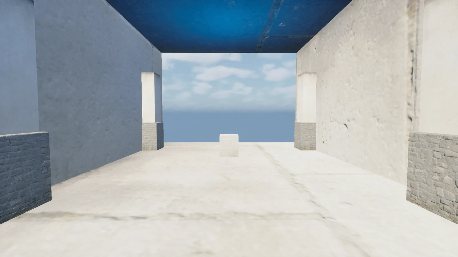 A bright, sunlit stone corridor with a blue-tinted ceiling opens onto a pale sandy floor and a blue sky-and-sea horizon, with a small white cube sitting alone in the distance.
